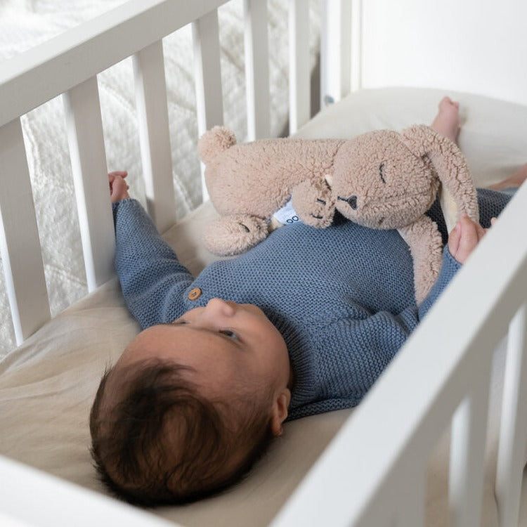 Baby hugging a comforting Doomoo Snoogy Bunny