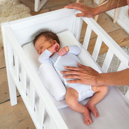 Baby sleeping peacefully on Doomoo Basics Supreme Sleep Small positioner.