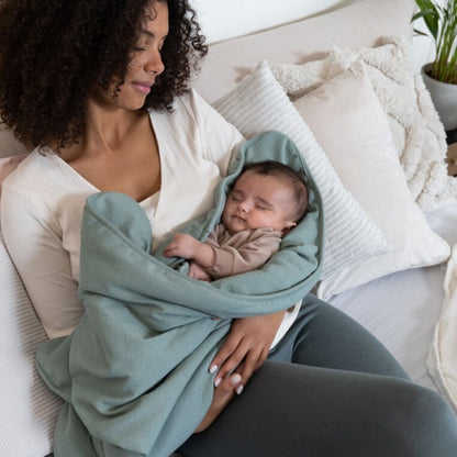 Baby wrapped in a soft Doomoo Dream Blanket