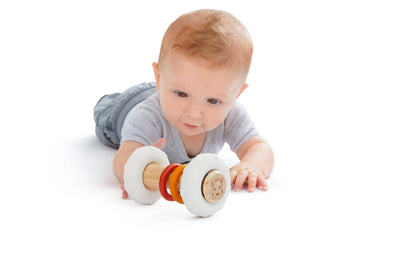 Baby holding Sophie la Girafe rattle