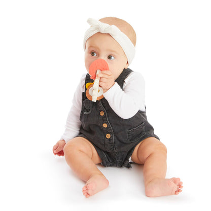 Baby playing with Sophie la girafe SLG Fragrances Ring, teething on it and smelling the scented medallions.